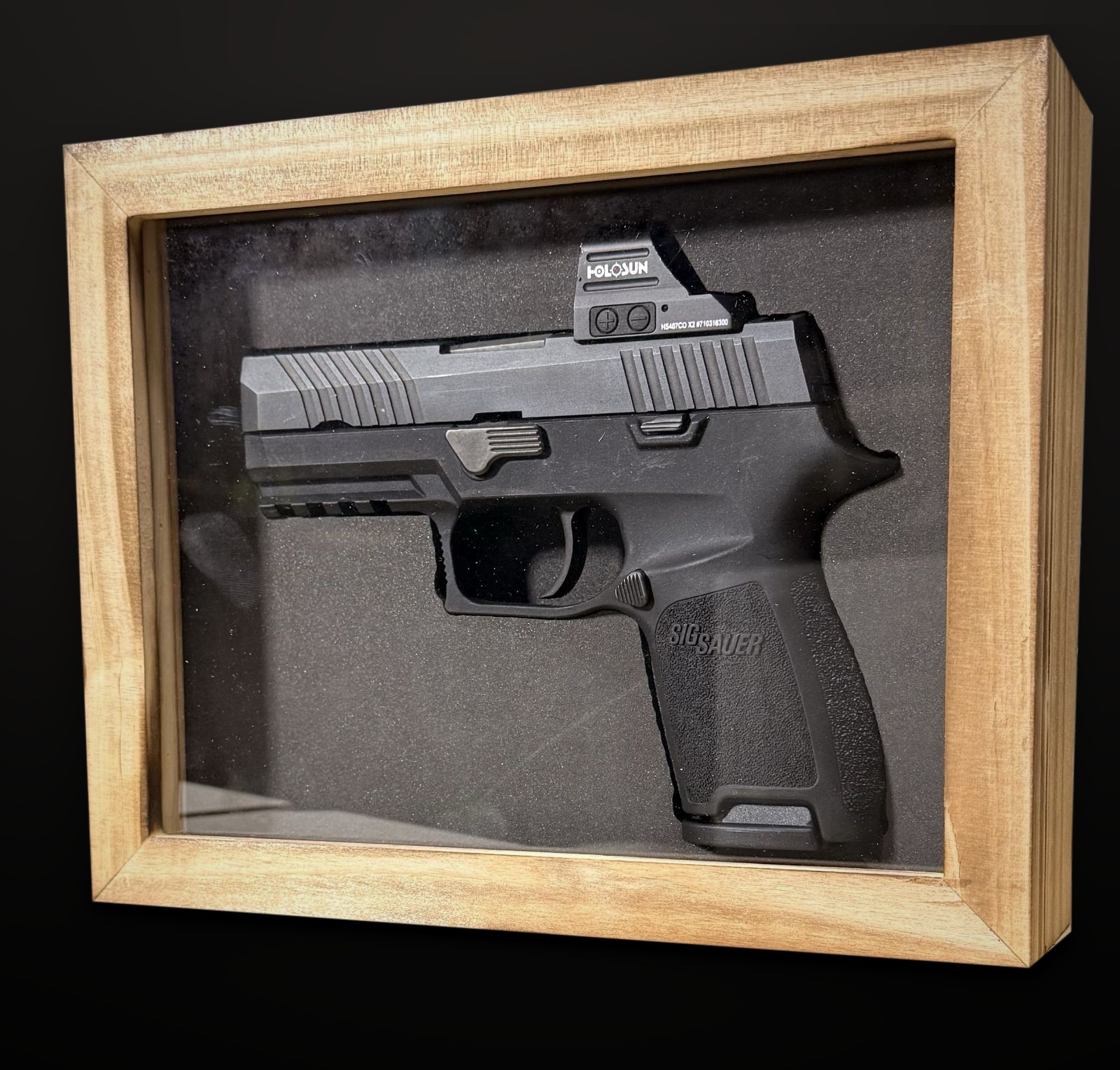 SIG P320 Compact with red dot in an 8 by 10 display case