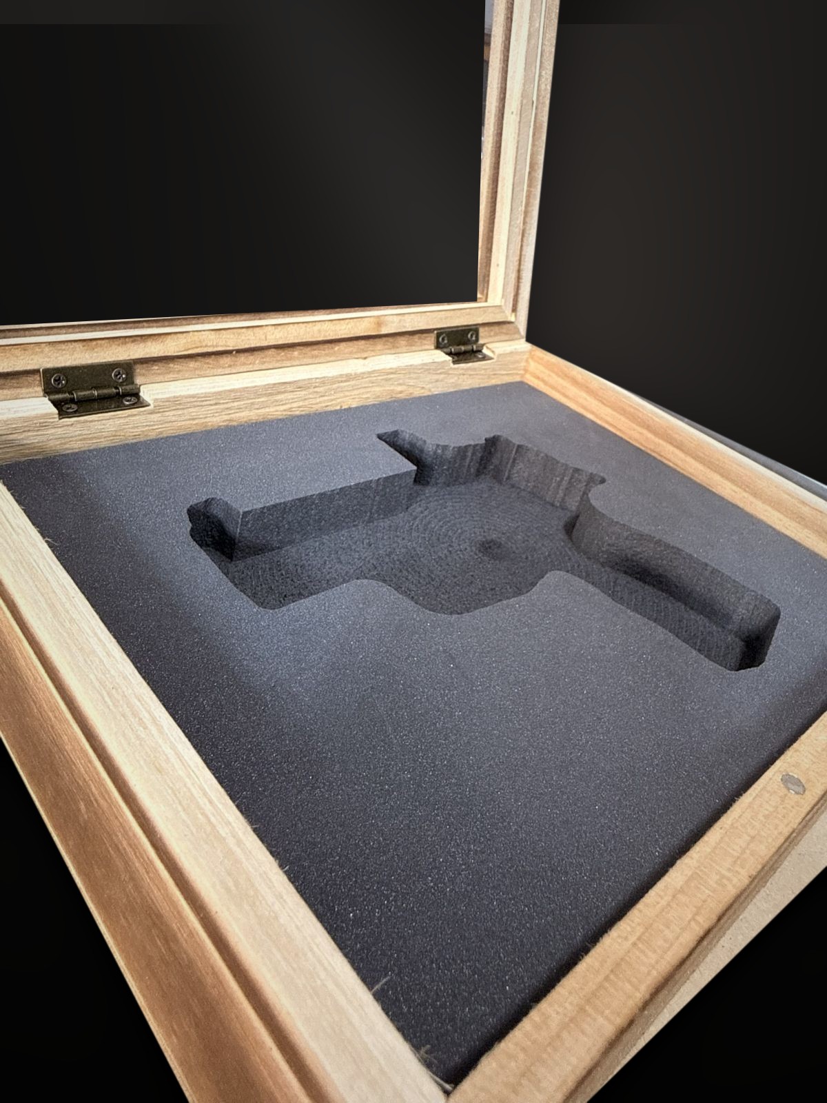 Empty CNC-cut foam pocket in the case, CNC machine behind